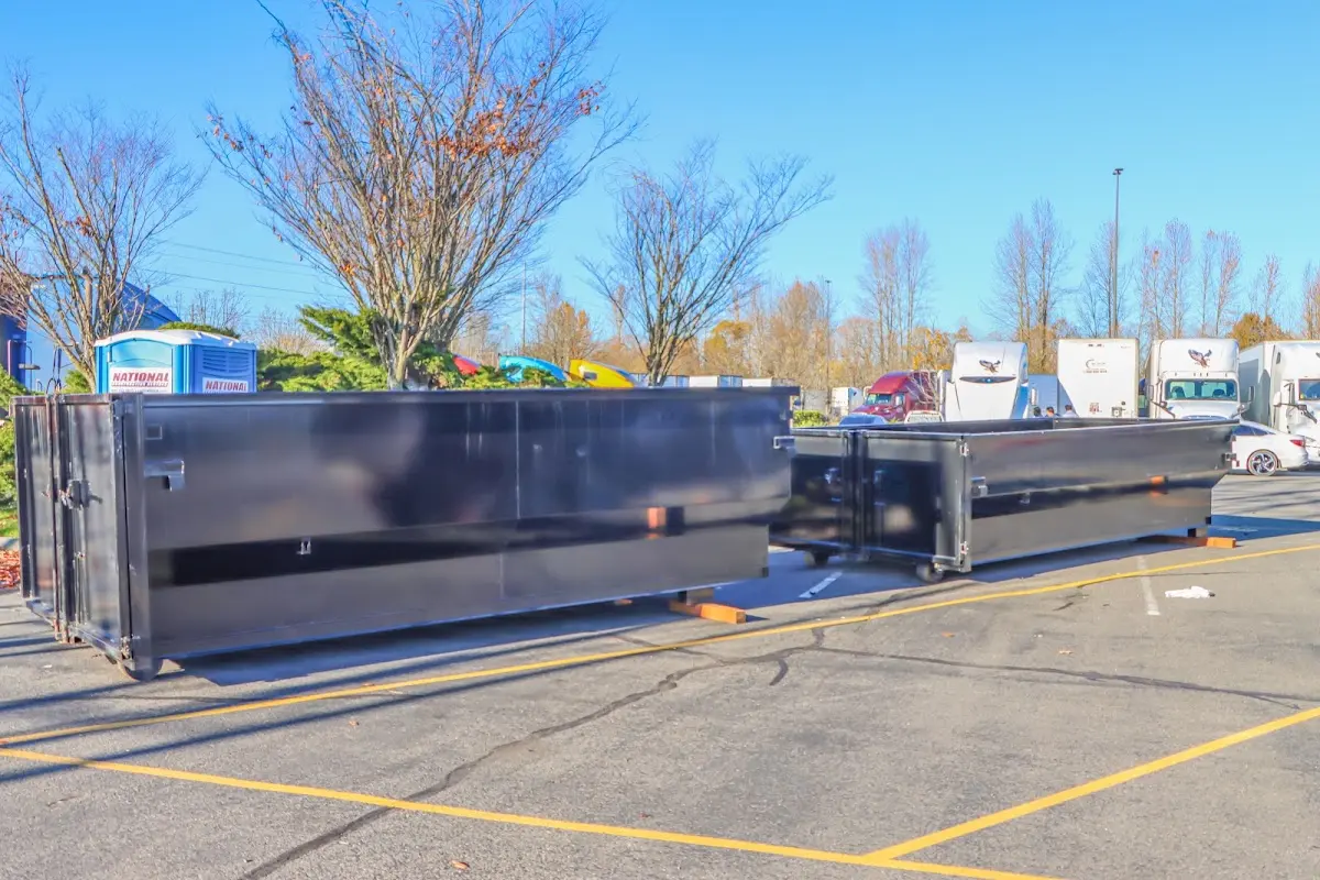 Professional dumpster rental service with roll-off container on residential driveway in Bluffdale